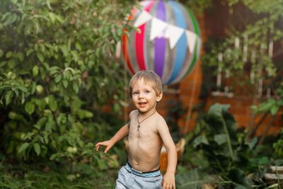 Portrait of cute boy standing outdoors