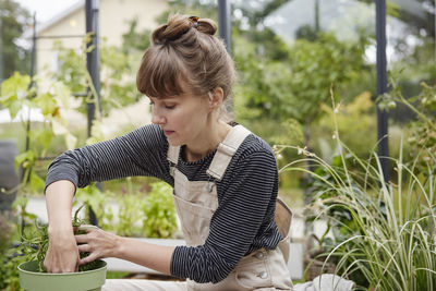 Woman gardening in greenhouse