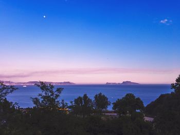 Scenic view of sea against clear sky at sunset