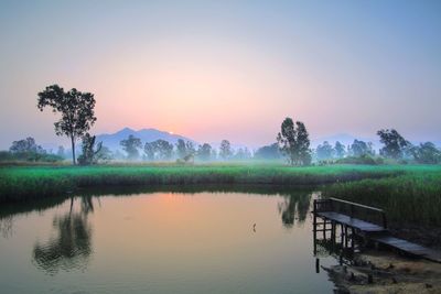 Scenic view of lake against sky during sunset