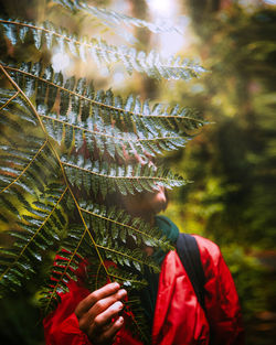 Portrait of woman with leaves on tree