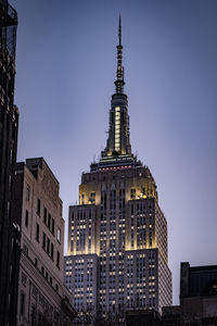 Low angle view of buildings against sky in city, manhattan, blue hour. 