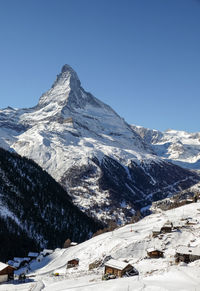 Scenic view of snow covered mountain against clear sky