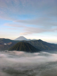 View of volcanic landscape against cloudy sky