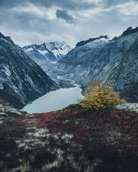 Scenic view of snowcapped mountain against cloudy sky