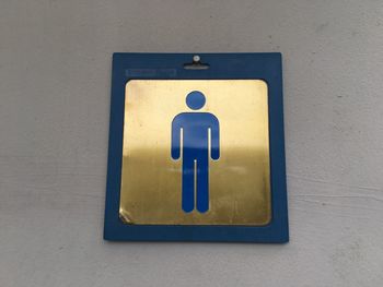 Close-up of male restroom symbol on wall