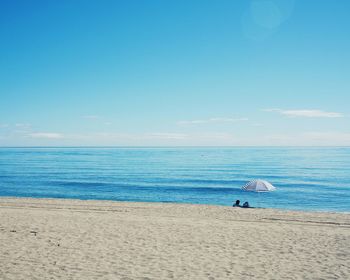 Scenic view of sea against blue sky