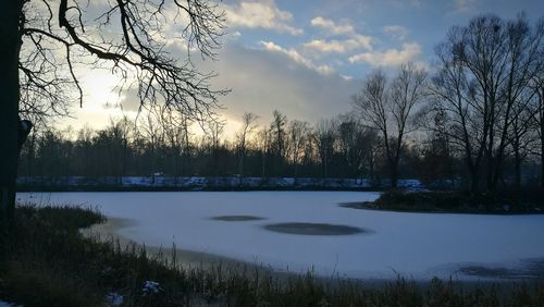 Scenic view of lake against sky at sunset