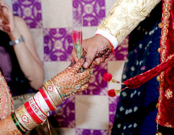 Low section of woman with tattoo on hand