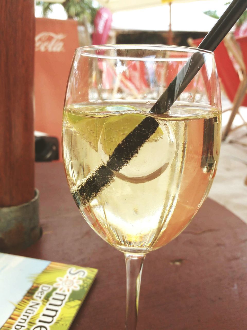 CLOSE-UP OF BEER GLASS ON TABLE