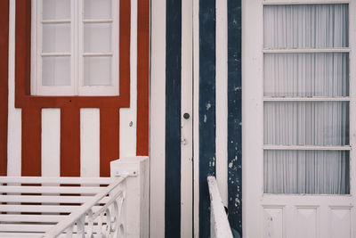 Door and window in the facade of two houses