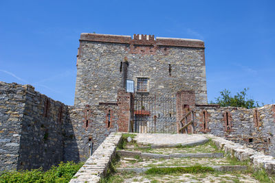 Old ruin building against blue sky