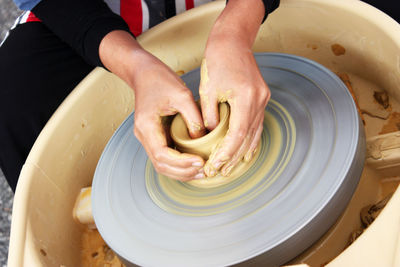 Midsection of person preparing food in kitchen