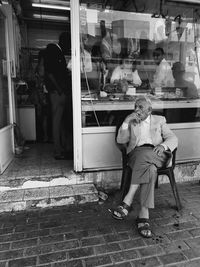 Rear view of people sitting on chair