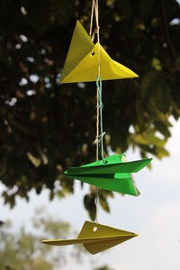 Close-up of yellow toy hanging on leaf