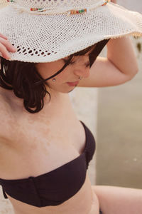 Young woman wearing black bikini in swimming pool