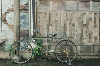 Bicycle parked against building