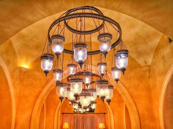 Low angle view of illuminated pendant light hanging from ceiling