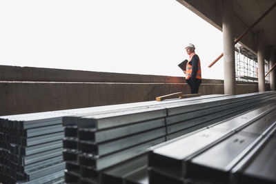 Man wearing safety vest in building under construction