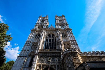 Low angle view of bell tower against blue sky