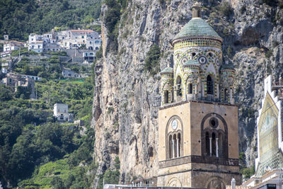 Low angle view of built structure against rock formation