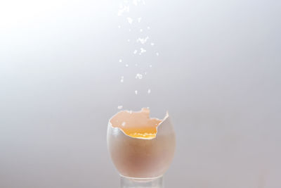 Close-up of drink in glass against white background