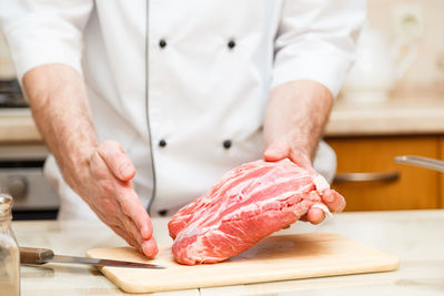 Midsection of man preparing food in kitchen