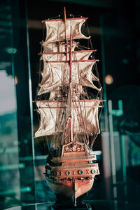 Close-up of illuminated lighting equipment hanging in glass