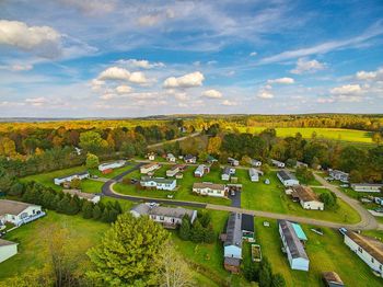 Aerial view of houses on field against sky