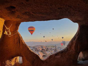 View of hot air balloon flying over rock