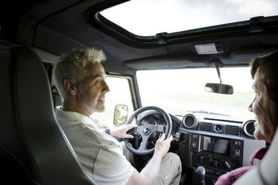 Senior couple on a trip in a cross country vehicle