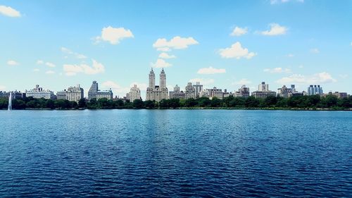 Panoramic view of city against cloudy sky