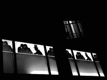 Low angle view of silhouette people in building