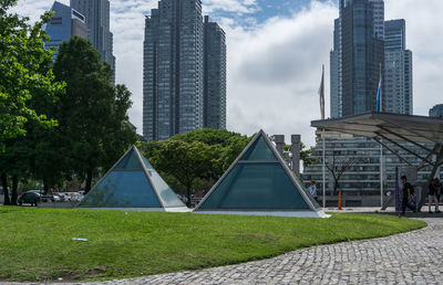 Modern buildings in city against sky