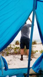 Low section of man working at tent