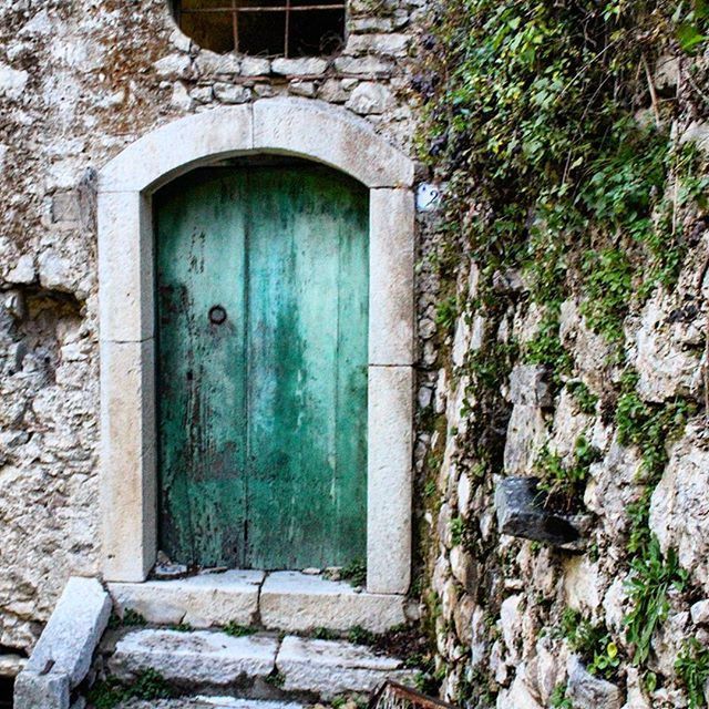 built structure, architecture, building exterior, door, house, window, closed, old, entrance, residential structure, stone wall, weathered, wall - building feature, day, abandoned, plant, wall, safety, outdoors, protection