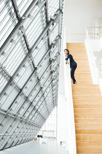 Female entrepreneur standing on steps in corridor