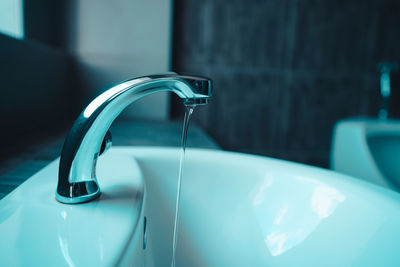 Close-up of faucet in bathroom