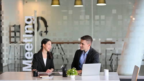 Portrait of businessman using mobile phone in office