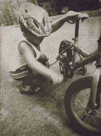 High angle view of boy riding bicycle on street