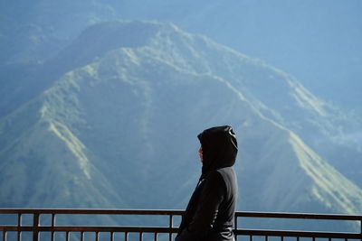 Rear view of woman standing on mountain