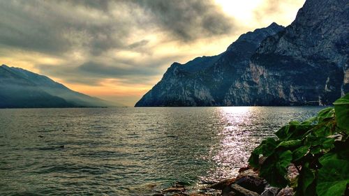 Scenic view of sea and mountains against sky