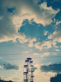 Low angle view of water tower against sky during sunset