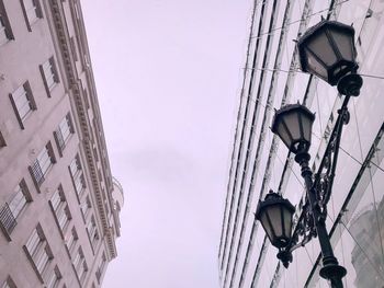 Low angle view of street light against buildings