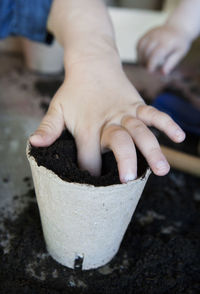 Child planting in pot