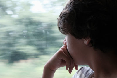 Close-up portrait of a teenage boy on train