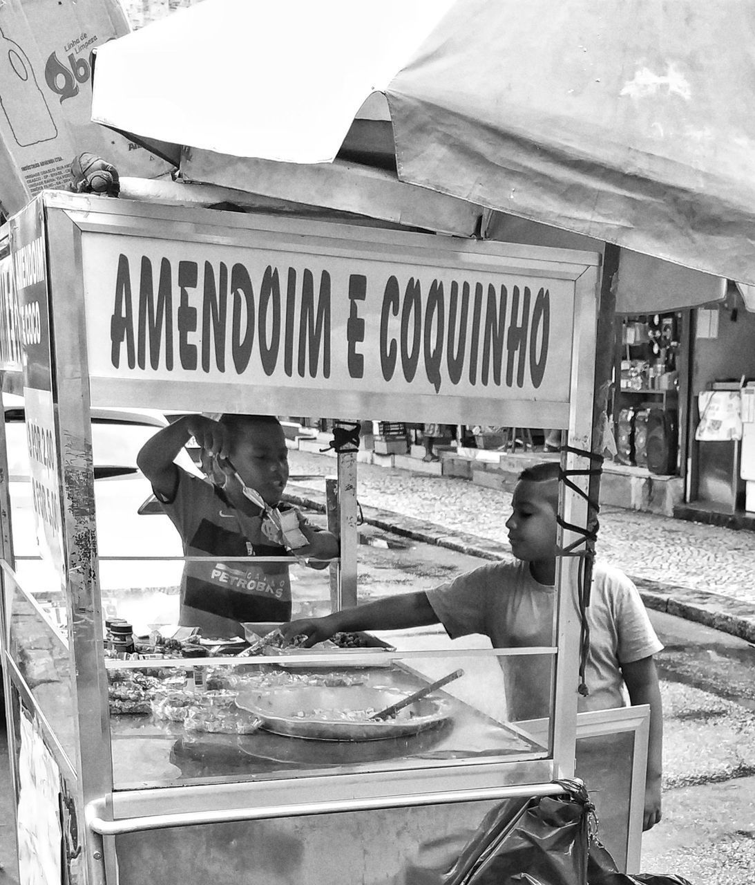 REAR VIEW OF PEOPLE AT MARKET