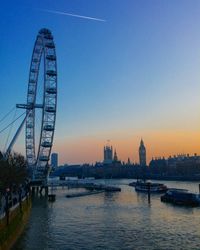 Thames river in city against clear sky