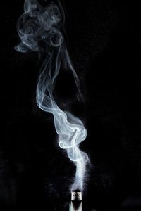 Close-up of smoke emitting from black background