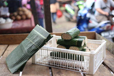 Close-up of food wrapped in banana leaves on wooden table